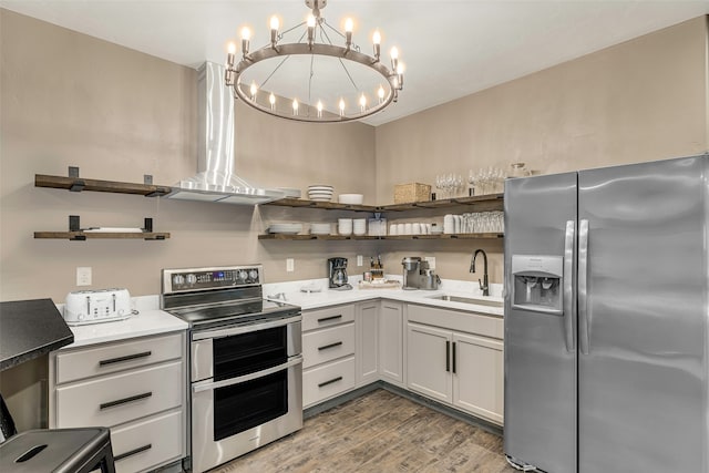 2870 US Highway 93 W, Whitefish, MT 59937 - kitchen featuring appliances with stainless steel finishes, white cabinetry, hardwood / wood-style flooring, sink, and a notable chandelier