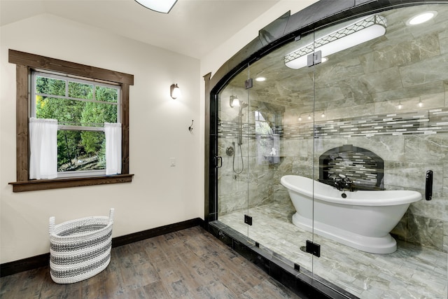 2870 US Highway 93 W, Whitefish, MT 59937 - bathroom with independent shower and bath, vaulted ceiling, and hardwood / wood-style flooring