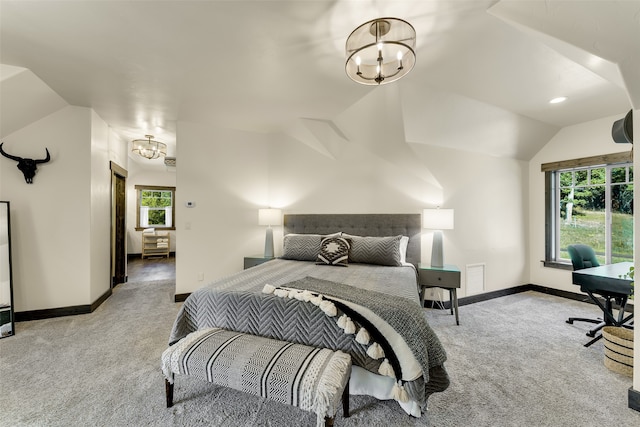 2870 US Highway 93 W, Whitefish, MT 59937 - bedroom with multiple windows, lofted ceiling, an inviting chandelier, and light colored carpet