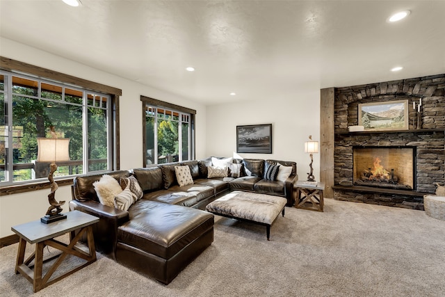 2870 US Highway 93 W, Whitefish, MT 59937 - living room featuring carpet floors, a stone fireplace, and plenty of natural light