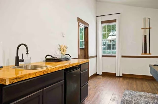 2870 US Highway 93 W, Whitefish, MT 59937 - bar with dark brown cabinets, vaulted ceiling, dark wood-type flooring, and sink
