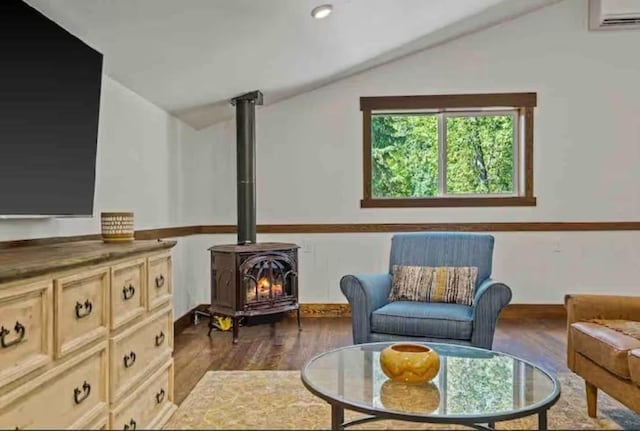 2870 US Highway 93 W, Whitefish, MT 59937 - sitting room with lofted ceiling, a wall unit AC, a wood stove, and dark wood-type flooring