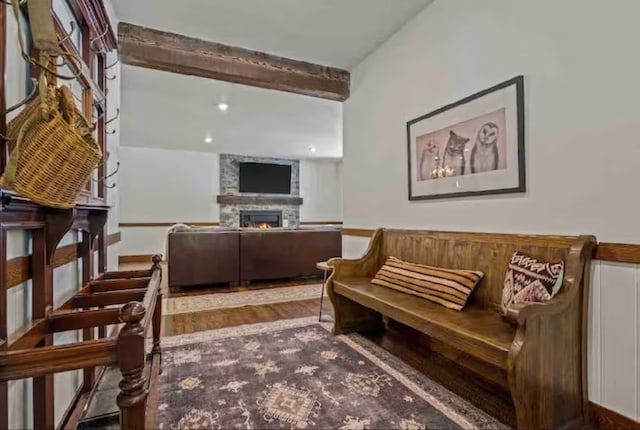 2870 US Highway 93 W, Whitefish, MT 59937 - living area with beamed ceiling, a fireplace, and hardwood / wood-style floors