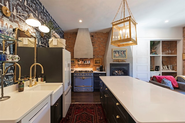 kitchen with high end stainless steel range, dark hardwood / wood-style flooring, ventilation hood, and a center island