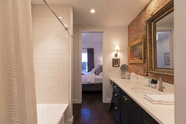 bathroom with vanity, hardwood / wood-style flooring, and shower / tub combo