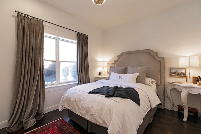 bedroom with dark hardwood / wood-style flooring