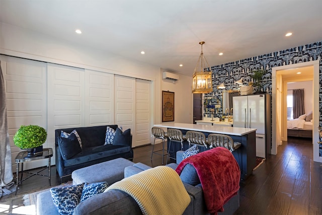 living room featuring dark wood-type flooring and a wall mounted AC