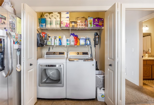 laundry room with independent washer and dryer and tile patterned floors