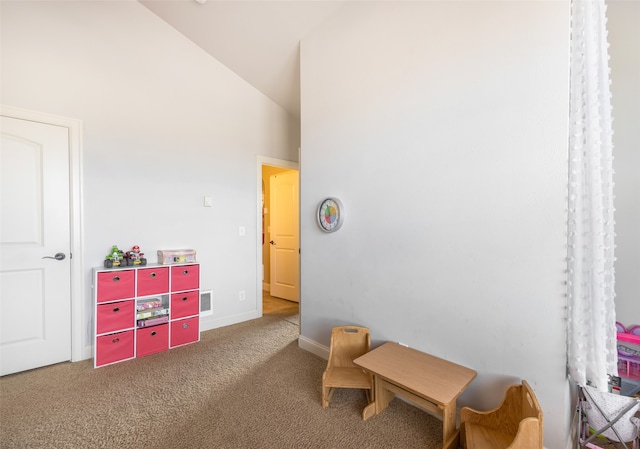 living area with carpet floors and high vaulted ceiling