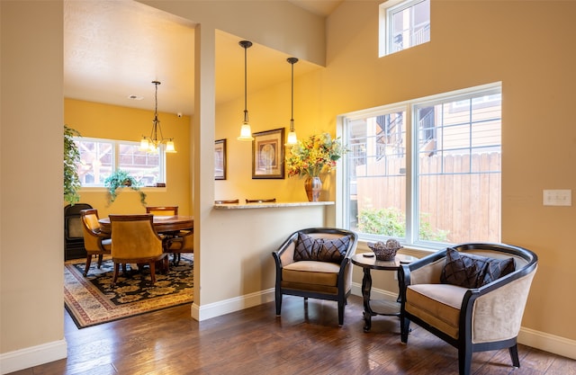 sitting room featuring dark wood-type flooring and a notable chandelier