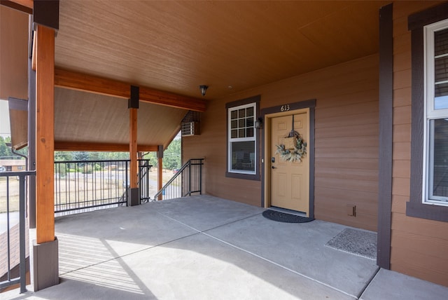 view of exterior entry featuring covered porch