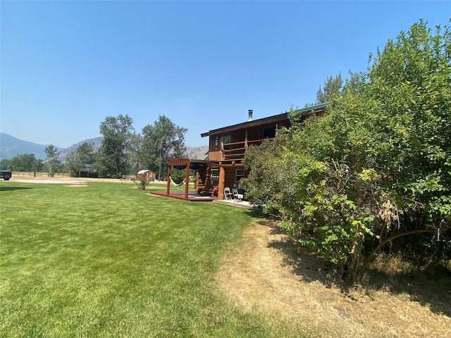 view of yard with a deck with mountain view