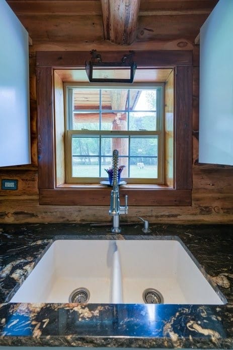 interior details featuring dark stone counters, wooden ceiling, and sink