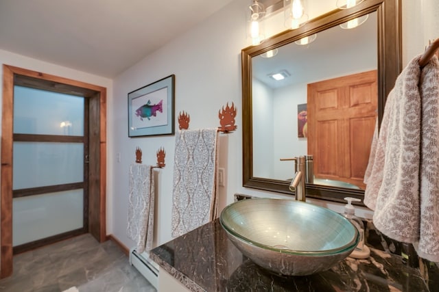 bathroom featuring a baseboard radiator and sink