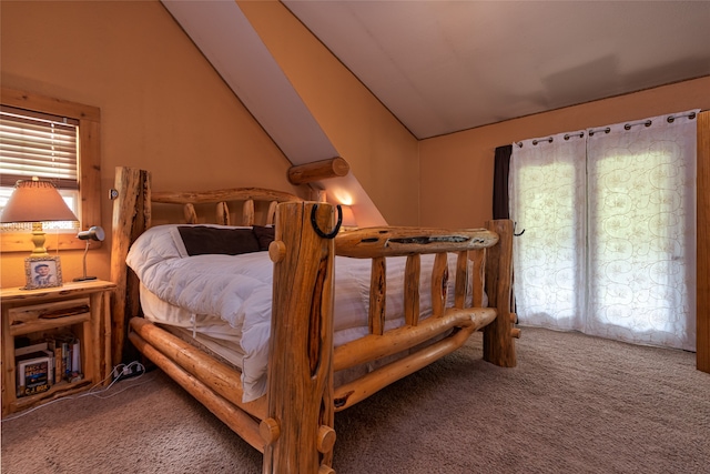 bedroom with lofted ceiling and carpet flooring