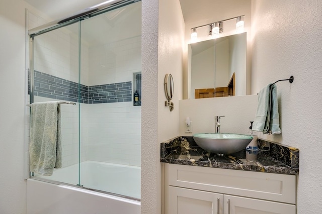 bathroom featuring vanity and combined bath / shower with glass door