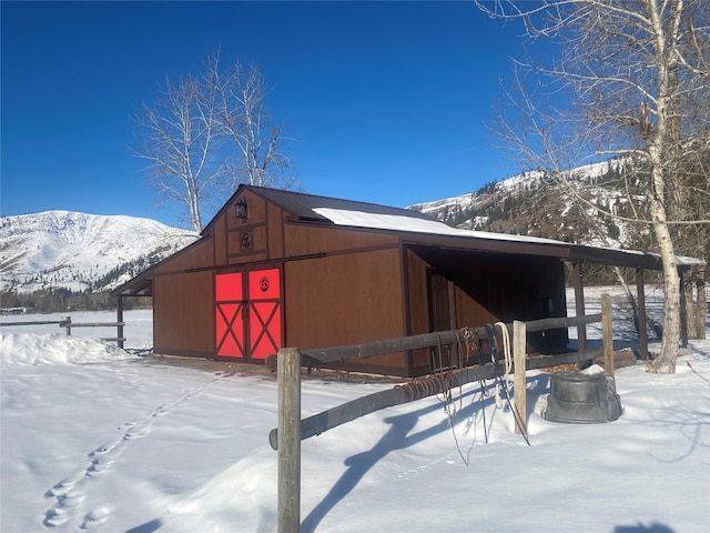 snow covered structure with a mountain view