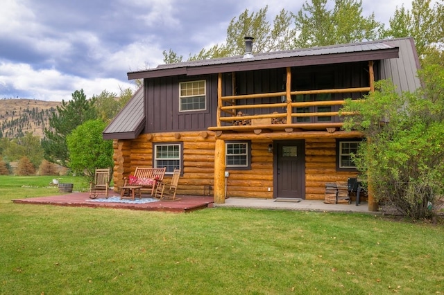 back of property featuring a patio and a yard