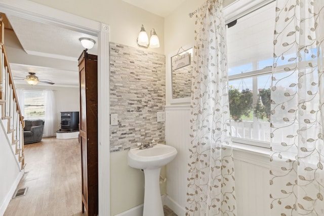 bathroom featuring ceiling fan, hardwood / wood-style flooring, and a textured ceiling