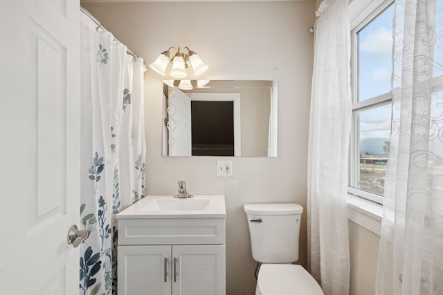 bathroom with vanity, toilet, and plenty of natural light