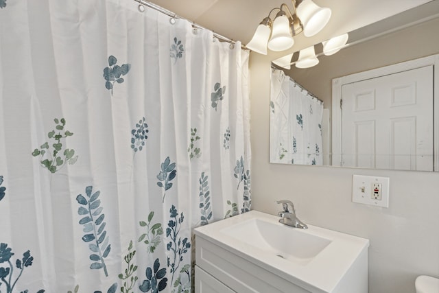 bathroom featuring walk in shower and vanity