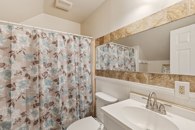 bathroom featuring walk in shower, vanity, and toilet