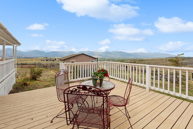 wooden deck with a mountain view