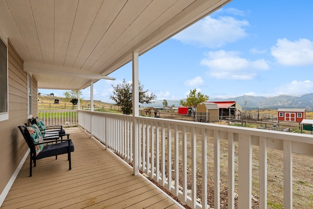 wooden terrace featuring a mountain view and a rural view