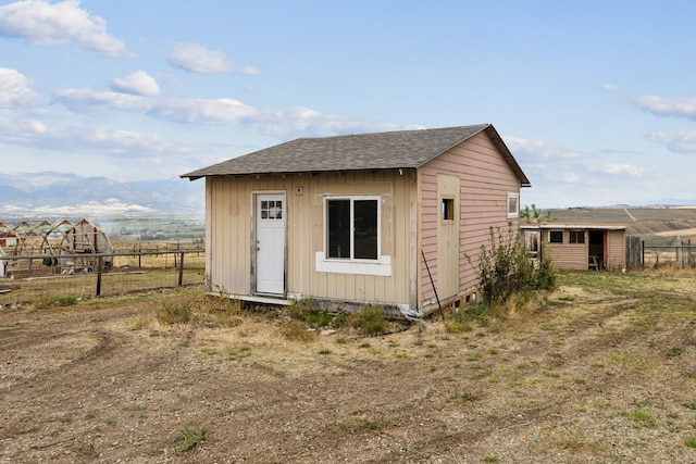 view of outbuilding featuring a rural view and a mountain view