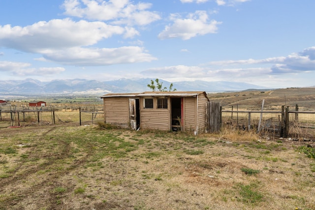 view of outdoor structure featuring a mountain view and a rural view