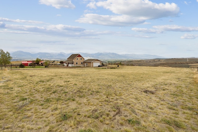 view of yard with a mountain view and a rural view