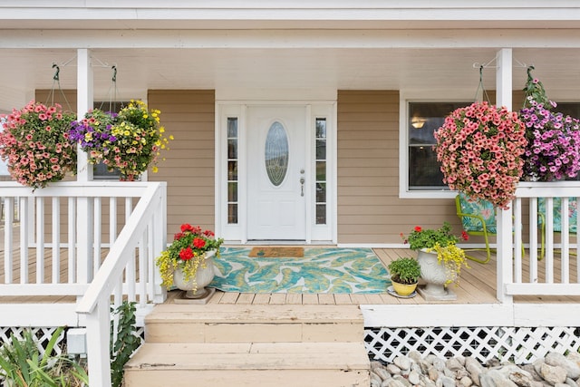 view of exterior entry with a porch