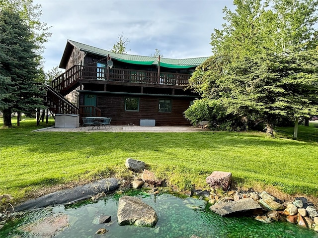 rear view of house with a patio, a yard, a wooden deck, and stairs