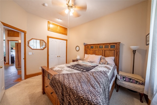 carpeted bedroom featuring a closet and ceiling fan