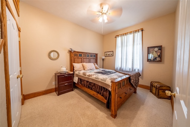 bedroom with light carpet and ceiling fan