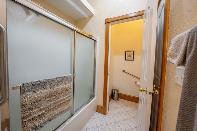 bathroom with tile patterned flooring and shower / bath combination with glass door