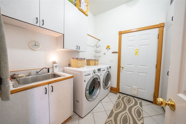 washroom featuring cabinets, separate washer and dryer, light tile patterned flooring, and sink