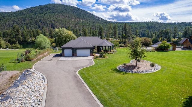 exterior space with a mountain view and a front yard