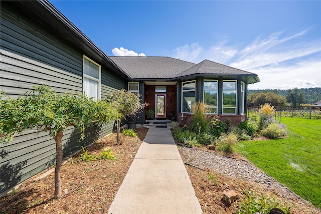 entrance to property with a lawn