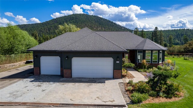 back of property with a yard and a mountain view