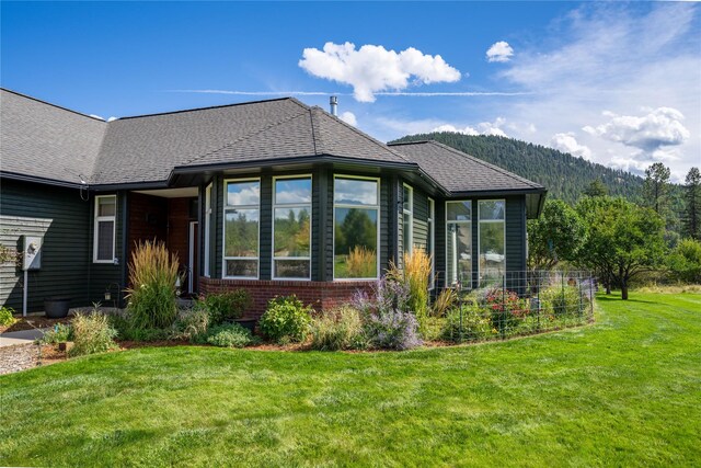 view of side of home with a lawn and a patio