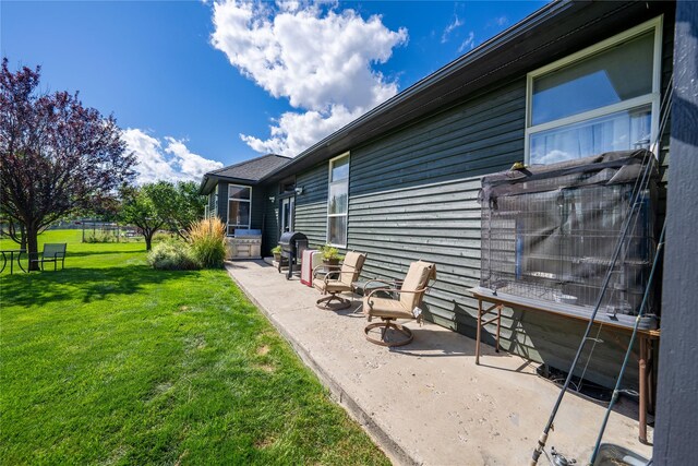 view of home's community with a lawn, a water view, and an outdoor fire pit