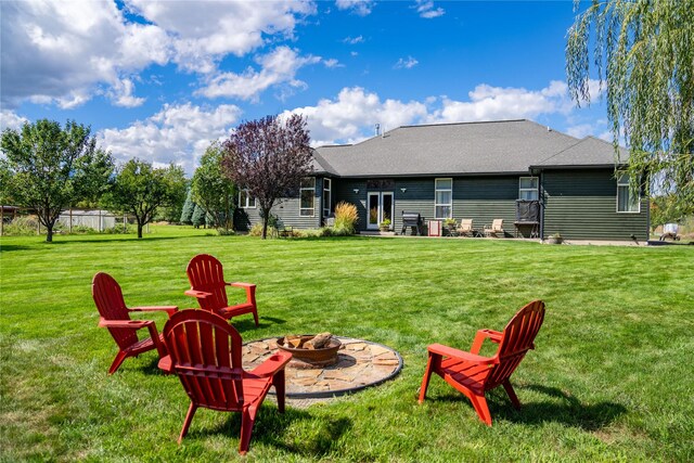 rear view of property featuring a mountain view and a yard