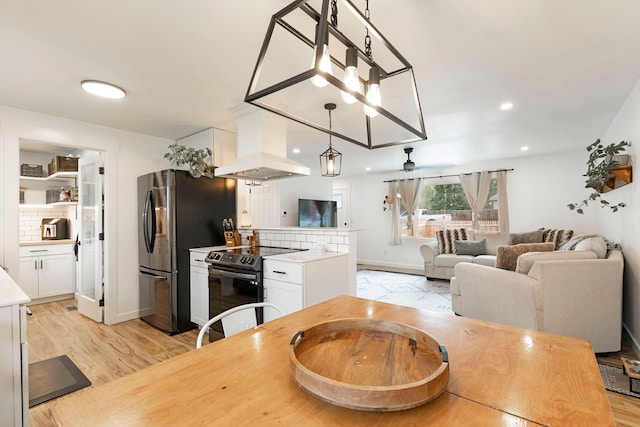 kitchen with backsplash, electric range oven, custom range hood, light hardwood / wood-style flooring, and white cabinets