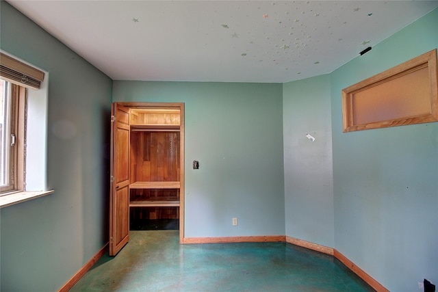 72878 Lemlama Trl, Arlee, MT 59821 - unfurnished bedroom featuring concrete floors and baseboards