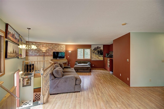 72878 Lemlama Trl, Arlee, MT 59821 - living room featuring baseboards, wood finished floors, and a chandelier