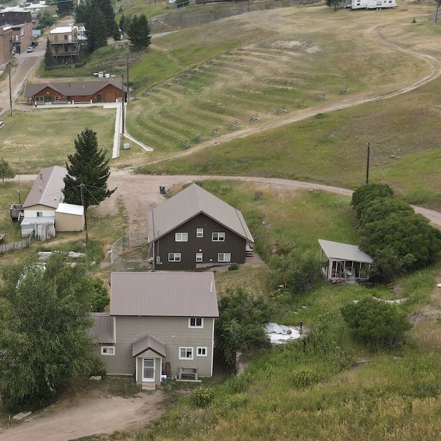 rear view of property featuring a yard and a balcony