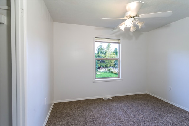 carpeted spare room with ceiling fan