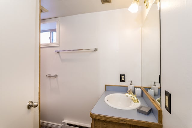 bathroom featuring vanity and baseboard heating