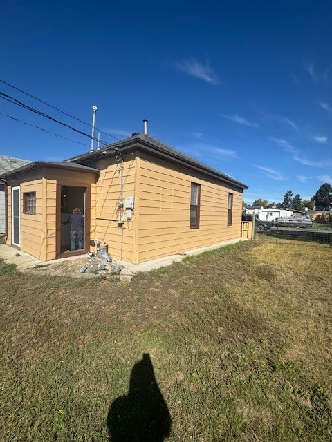 view of side of home with a lawn